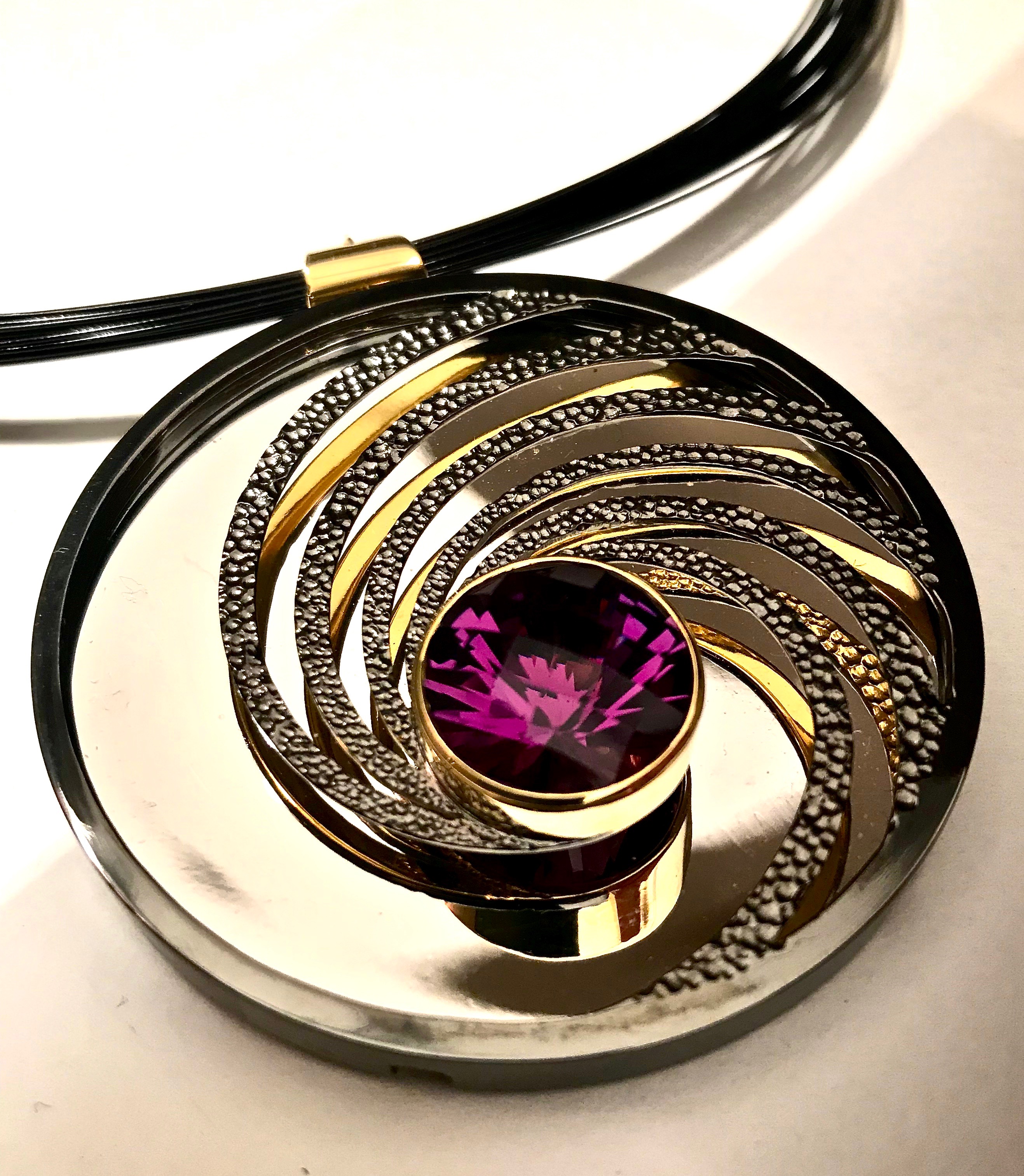 <a href="/node/298">Swinging on a Star. TDark Amethyst / Silver / Part Gilded part Rhodium Plate / the mirror on the inside back will reflect whatever its facing - here it’s the Sky.</a>