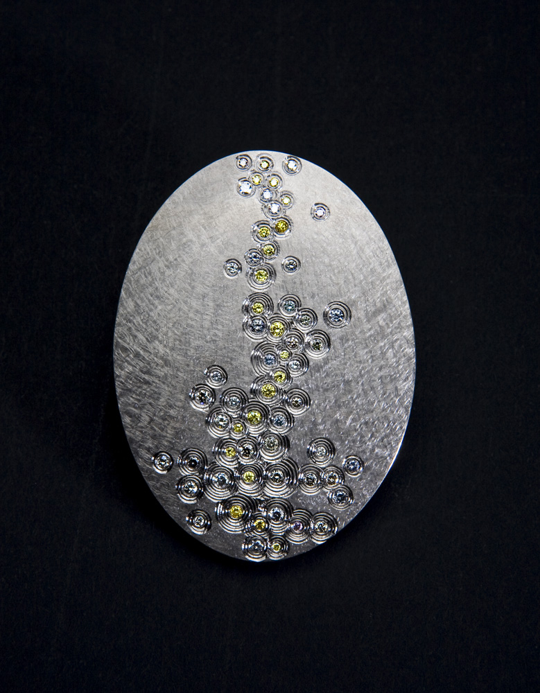 <a href="/jewellery/golden-thread-brooch-photo-12-commission-piece-18-ct-white-gold-hand-engraved-set-natural">Golden Thread Brooch, photo 1/2. Commission piece, 18 ct White gold. hand engraved, set with natural grey and yellow diamonds. Photo : Simon B Armitt.</a>