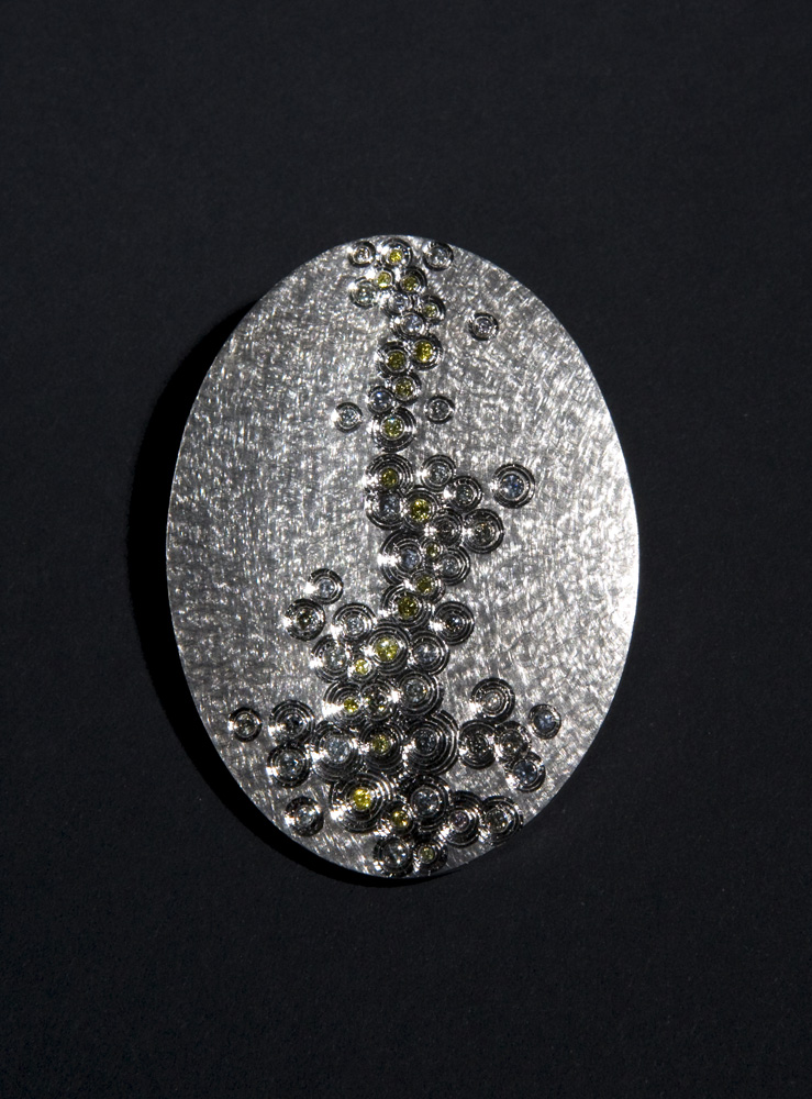 <a href="/jewellery/golden-thread-brooch-photo-22-commission-piece-18-ct-white-gold-hand-engraved-set-natural">Golden Thread Brooch, photo 2/2. Commission piece, 18 ct White gold. hand engraved, set with natural grey and yellow diamonds. Photo : Simon B Armitt.</a>