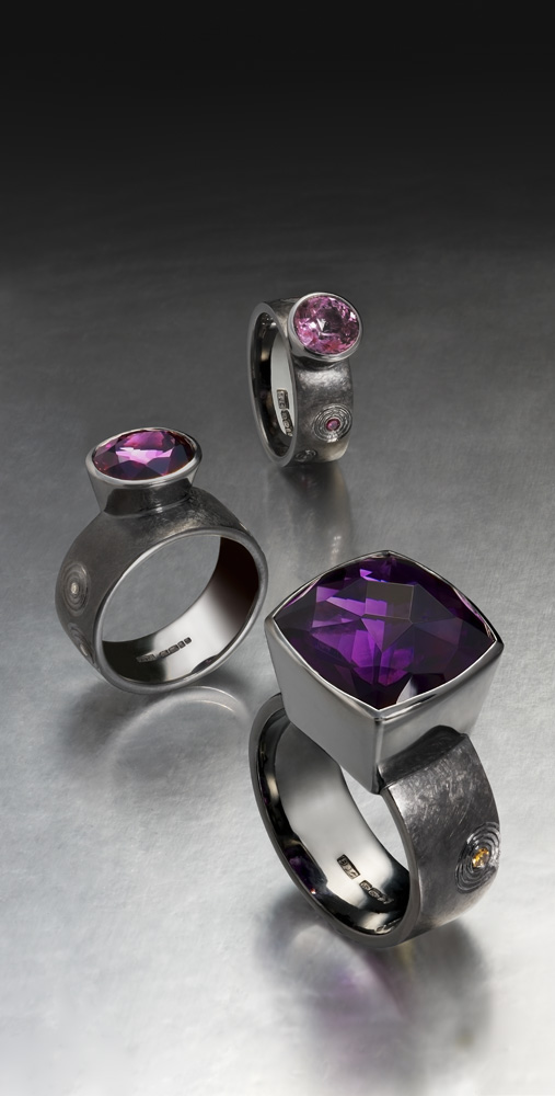 <a href="/jewellery/group-cocktail-rings-silver-finished-black-rhodium-hand-engraved-zen-garden-pattern-form">Group of Cocktail Rings. Silver finished in Black Rhodium. Hand engraved in &quot;Zen&quot; garden pattern form. Amethyst, purple and mauve Spinels, ring shanks set with treated and natural coloured diamonds. Photo Simon B Armitt </a>